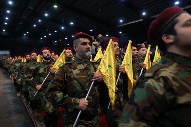 (FILES) Militants with the Lebanese Shiite movement Hezbollah, parade in Beirut's southern suburbs on April 14, 2023, to mark Al-Quds (Jerusalem) Day, a commemoration in support of the Palestinian people celebrated annually on the last Friday of the Muslim fasting month of Ramadan. Lebanon's army said on Januray 8, 2026, that it had completed the first phase of its plan to disarm Hezbollah in south Lebanon, while Israel called the efforts encouraging but "far from sufficient". Under heavy US pressure and amid fears of expanded Israeli strikes, Lebanon has committed to disarming the Iran-backed militant group, which was badly weakened after more than a year of hostilities including two months of all-out war that ended with a November 2024 ceasefire. (Photo by ANWAR AMRO / AFP)