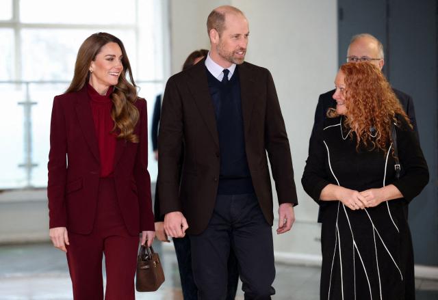 Britain's Prince William (C), Prince of Wales and Catherine (L), Princess of Wales pay a visit to Charing Cross Hospital in west London on January 8, 2026, to highlight the work of NHS staff and volunteers. (Photo by Isabel Infantes / POOL / AFP)