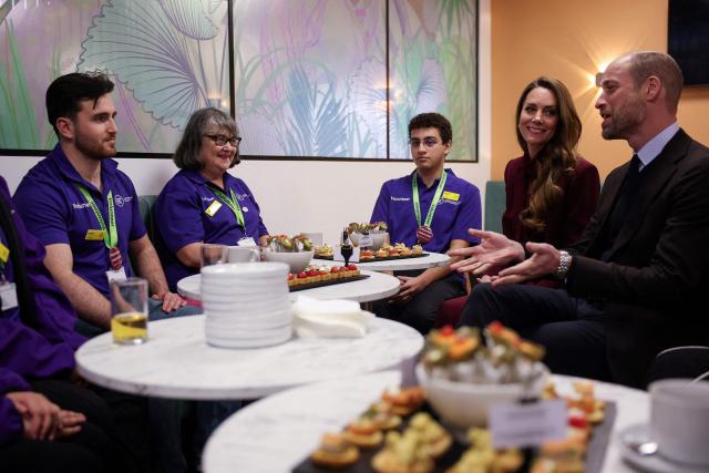 Britain's Prince William (R), Prince of Wales and Catherine (2nd R), Princess of Wales meet with volunteers of Imperial Health Charity during a visit to Charing Cross Hospital in west London on January 8, 2026, to highlight the work of NHS staff and volunteers. (Photo by Isabel Infantes / POOL / AFP)