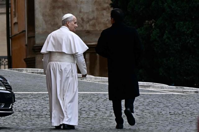Pope Leo XIV walks with his private secretary Edgard Iván Rimaycuna Inga during a two-days meeting with cardinals as part of an extraordinary Consistory in The Vatican on January 8, 2026. (Photo by Filippo MONTEFORTE / AFP)