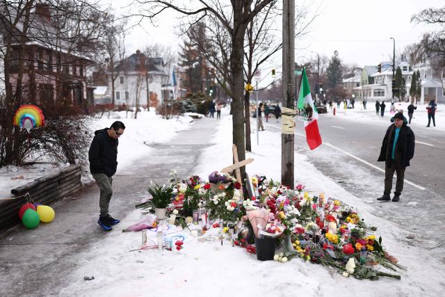 People gather at a makeshift memorial for 37-year-old Renee Nicole Good, who was shot and killed at point blank range on January 7 by a US Immigration and Customs Enforcement (ICE) agent as she apparently tried to drive away from agents who were crowding around her car, in Minneapolis, Minnesota, on January 8, 2026. A US Immigration and Customs Enforcement (ICE) agent shot and killed an American woman on the streets of Minneapolis January 7, leading to huge protests and outrage from local leaders who rejected White House claims she was a domestic terrorist. (Photo by CHARLY TRIBALLEAU / AFP)