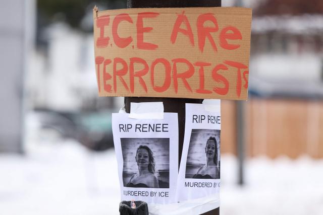 A picture of Renee Nicole Good is displayed near a makeshift memorial for Good, who was shot and killed at point blank range on January 7 by a US Immigration and Customs Enforcement (ICE) agent as she apparently tried to drive away from agents who were crowding around her car, in Minneapolis, Minnesota, on January 8, 2026. A US Immigration and Customs Enforcement (ICE) agent shot and killed an American woman on the streets of Minneapolis January 7, leading to huge protests and outrage from local leaders who rejected White House claims she was a domestic terrorist. (Photo by CHARLY TRIBALLEAU / AFP)