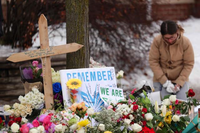 TOPSHOT - People gather at a makeshift memorial for 37-year-old Renee Nicole Good, who was shot and killed at point blank range on January 7 by a US Immigration and Customs Enforcement (ICE) agent as she apparently tried to drive away from agents who were crowding around her car, in Minneapolis, Minnesota, on January 8, 2026. A US Immigration and Customs Enforcement (ICE) agent shot and killed an American woman on the streets of Minneapolis January 7, leading to huge protests and outrage from local leaders who rejected White House claims she was a domestic terrorist. (Photo by CHARLY TRIBALLEAU / AFP)