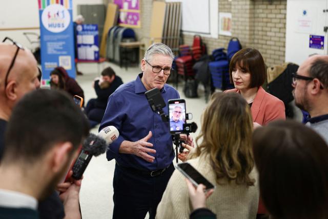 Britain's Prime Minister Keir Starmer (C) speaks to members of the media during a visit to a "family hub" at St. Mary's Church Hall in Goldington, Bedfordshire, north of London on January 8, 2026, to highlight the government's work on child poverty and support families with the cost of living. (Photo by HENRY NICHOLLS / POOL / AFP)