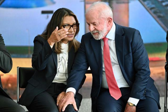 Brazil’s President Luiz Inacio Lula da Silva speaks with First Lady Rosangela 'Janja' Da Silva during the Ceremony in Defense of Democracy marking the third anniversary of the attempted coup d'йtat involving the invasion and destruction of buildings of the three branches of government, at the Planalto Palace in Brasнlia, on January 8, 2026. (Photo by Evaristo Sa / AFP)