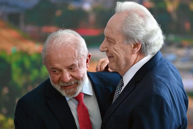 Brazil’s President Luiz Inacio Lula da Silva greets Brazil’s Justice Minister Ricardo Lewandowski during the Ceremony in Defense of Democracy marking the third anniversary of the attempted coup d'йtat involving the invasion and destruction of buildings of the three branches of government, at the Planalto Palace in Brasнlia, on January 8, 2026. (Photo by Evaristo Sa / AFP)
