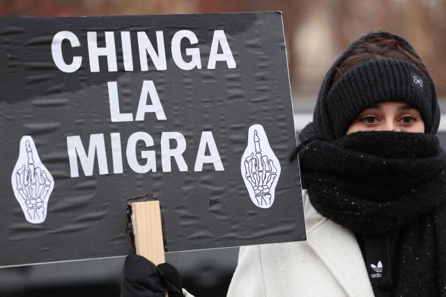 A woman holds a sign near the street where 37-year-old Renee Nicole Good was shot and killed at point blank range on January 7 by a US Immigration and Customs Enforcement (ICE) agent as she apparently tried to drive away from agents who were crowding around her car, in Minneapolis, Minnesota, on January 8, 2026. A US Immigration and Customs Enforcement (ICE) agent shot and killed an American woman on the streets of Minneapolis January 7, leading to huge protests and outrage from local leaders who rejected White House claims she was a domestic terrorist. (Photo by CHARLY TRIBALLEAU / AFP)
