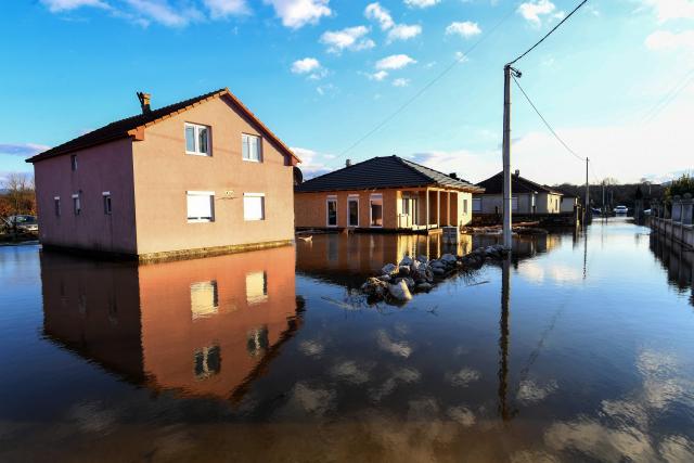 Flooded houses and homesteads are seen in Montenegro's town of Danilovgrad, on January 8, 2026. River Zeta has flooded the areas of Danilovgrad and village of Spuz, just north of the capital Podgorica, after heavy rain over the area. (Photo by SAVO PRELEVIC / AFP)