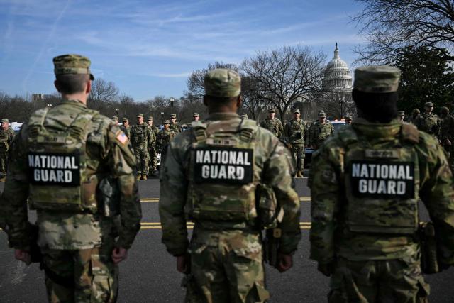 Members of the National Guard look on during a procession for Metropolitan Police Department (MPD) officer Terry Bennett, who passed away on January 7 after being struck on a highway while helping a stranded driver on December 23, 2025, in Washington, DC, on January 8, 2026. (Photo by Brendan SMIALOWSKI / AFP)