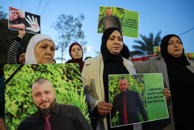 Israeli-Arab demonstrators hold pictures of victims of violence during a protest organised by a left leaning NGO, Standing Together, in response to a sharp rise in murders within Israel's Arab society, demanding that the government present a solution to curb the violence in Turan on January 8, 2026. (Photo by JACK GUEZ / AFP)