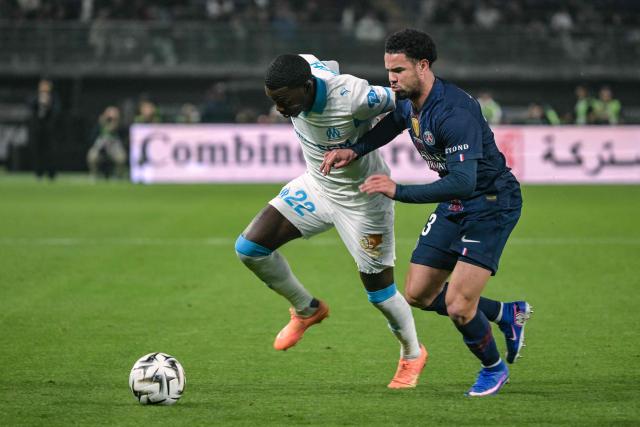 Marseille's US forward #22 Timothy Weah (L) fights for the ball with Paris Saint-Germain's French midfielder #33 Warren Zaire-Emery during the French Champions' Trophy (Trophee des Champions) football match between Paris Saint-Germain (PSG) and Olympique de Marseille (OM) at the Jaber Al-Ahmad International Stadium in Kuwait City on January 8, 2026. (Photo by Yasser AL ZAYYAT / AFP)