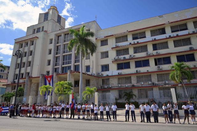 Cubans take part in the 67th anniversary of the Caravan of Freedom to commemorate Fidel Castro’s historic entry into the city which marked the start of the Cuban Revolution, in front of the building of the Grupo de Administraciуn Empresarial S.A.(GAESA), a conglomerate controlled by Cuba's Revolutionary Armed Forces (FAR), in Havana on January 8, 2026. (Photo by ADALBERTO ROQUE / AFP)