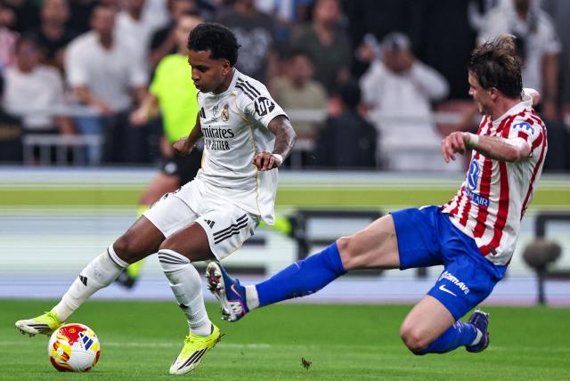 Atletico Madrid's English midfielder #04 Conor Gallagher tackles Real Madrid's Brazilian forward #11 Rodrygo during the Spanish Supercup semi-final football match between Atletico Madrid and Real Madrid at King Abdullah Sports City in Jeddah on January 8, 2026. (Photo by Fadel SENNA / AFP)