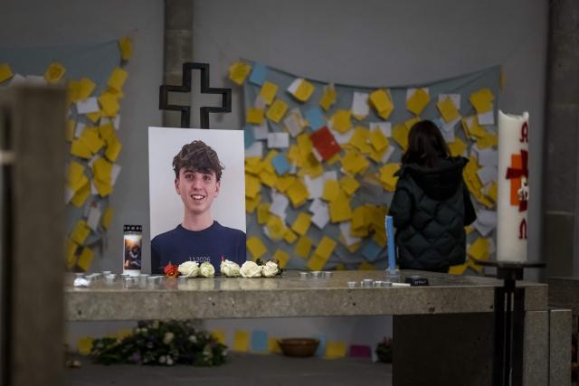 A picture of 16 year old Arthur Brodard who died in Crans-Montana is seen next to messages inside the temple after its funeral in Lutry on January 8, 2026. Fourty people, most of them teenagers, were killed while 116 were injured in a fire that ripped through a bar in the luxury Alpine ski resort of Crans-Montana on New Year's Eve. (Photo by Fabrice COFFRINI / AFP)
