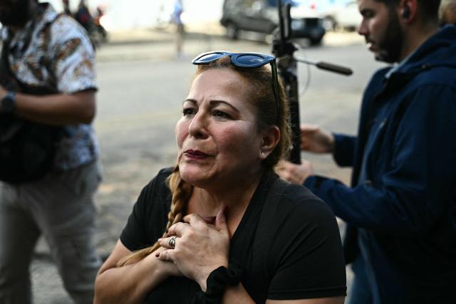 Atali Cabrejo, the mother of imprisoned Juan Jose Freitas, 35, of Vente Venezuela Vargas, gestures nearby the entrance to El Helicoide -a facility and prison owned by the Venezuelan government and used for both regular and political prisoners of the Bolivarian National Intelligence Service (SEBIN)- in Caracas on January 8, 2026. The President of the National Assembly of Venezuela Jorge Rodriguez announced the imminent release of a significant number of Venezuelans and foreign nationals "in order to contribute to and collaborate in the effort that we must all make to achieve coexistence". (Photo by RONALDO SCHEMIDT / AFP)