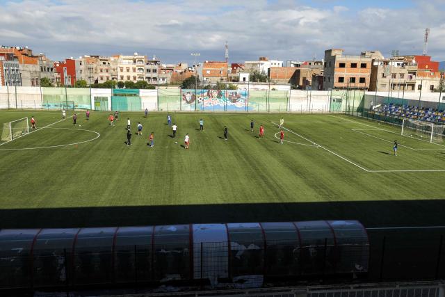 Youths play on the municipal football field named after Moroccan international Achraf Hakimi in Ksar El-Kebir in northern Morocco on January 8, 2026. (Photo by Abdel Majid BZIOUAT / AFP)