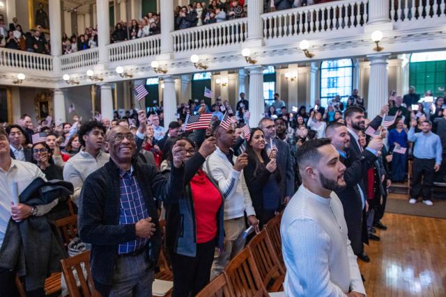New citizens take the Pledge of Allegiance during the naturalization ceremony at Faneuil Hall in Boston, Massachusetts on January 8, 2026. (Photo by Joseph Prezioso / AFP)