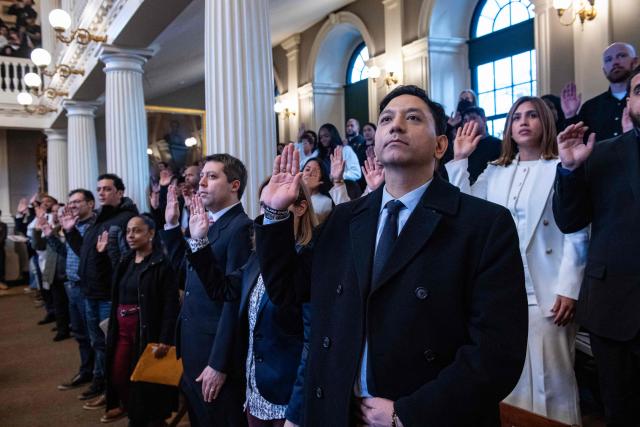 Immigrants take the Oath of Allegiance to become US citizens in the great hall at Faneuil Hall in Boston, Massachusetts on January 8, 2026. (Photo by Joseph Prezioso / AFP)