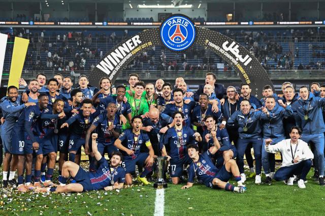 PSG's players celebrate with the trophy after winning the French Champions' Trophy (Trophee des Champions) football match between Paris Saint-Germain (PSG) and Olympique de Marseille (OM) at the Jaber Al-Ahmad International Stadium in Kuwait City on January 8, 2026. (Photo by YASSER AL-ZAYYAT / AFP)