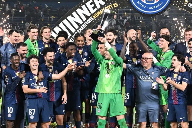 PSG's players celebrate with the trophy after winning the French Champions' Trophy (Trophee des Champions) football match between Paris Saint-Germain (PSG) and Olympique de Marseille (OM) at the Jaber Al-Ahmad International Stadium in Kuwait City on January 8, 2026. (Photo by YASSER AL-ZAYYAT / AFP)