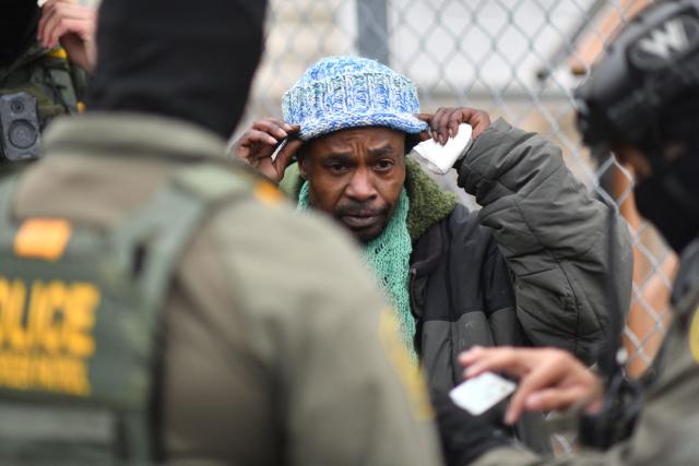 US Border Patrol agents detain an unidentified man of Somali descent in Minneapolis, Minnesota, on January 8, 2026. A US Immigration and Customs Enforcement (ICE) agent shot and killed an American woman on the streets of Minneapolis January 7, leading to huge protests and outrage from local leaders who rejected White House claims she was a domestic terrorist. The woman, identified in local media as 37-year-old Renee Nicole Good, was hit at point blank range as she apparently tried to drive away from agents who were crowding around her car, which they said was blocking their way. (Photo by Octavio JONES / AFP)