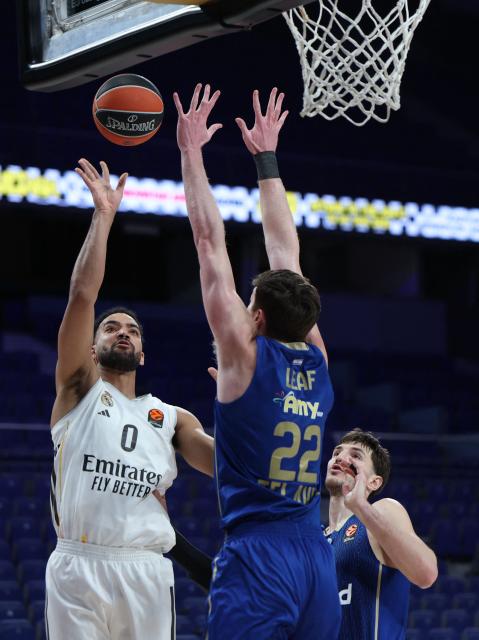 Real Madrid's Canadian forward #00 Trey Lyles attempts a shot defended by Maccabi's US forward #22 TJ Leaf during the Euroleague basketball match between Real Madrid and Maccabi Tel Aviv at Movistar Arena in Madrid on January 8, 2026. Real Madrid plays a EuroLeague basketball game against Maccabi Rapyd Tel Aviv behind closed doors over security concerns, the latest disruption to Spanish sport linked to Israeli participation. (Photo by Thomas COEX / AFP)
