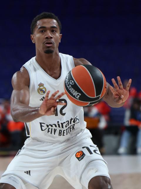 Real Madrid's French guard #12 Theo Maledon controls the ball during the Euroleague basketball match between Real Madrid and Maccabi Tel Aviv at Movistar Arena in Madrid on January 8, 2026. Real Madrid plays a EuroLeague basketball game against Maccabi Rapyd Tel Aviv behind closed doors over security concerns, the latest disruption to Spanish sport linked to Israeli participation. (Photo by Thomas COEX / AFP)