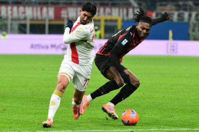 Genoa's Icelandic forward #77 Mikael Egill Ellertsson fights for the ball with AC Milan's Portuguese forward #10 Rafael Leao during the Italian Serie A football match between AC Milan and Genoa at San Siro stadium in Milan, northern Italy, on January 8, 2025. (Photo by Stefano RELLANDINI / AFP)