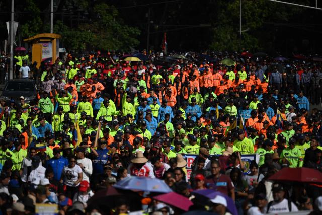 Members of the Venezuelan National Police attend a march in Caracas on January 8, 2026, to demand the release of deposed Venezuelan president Nicolas Maduro and his wife Cilia Flores, snatched and taken to New York on January 3 to face trial on drug and weapons charges. Venezuela on January 8 announced the release of a "large number" of prisoners, some of them foreigners, in an apparent concession to the United States after its ouster of ruler Nicolas Maduro. (Photo by Federico PARRA / AFP)