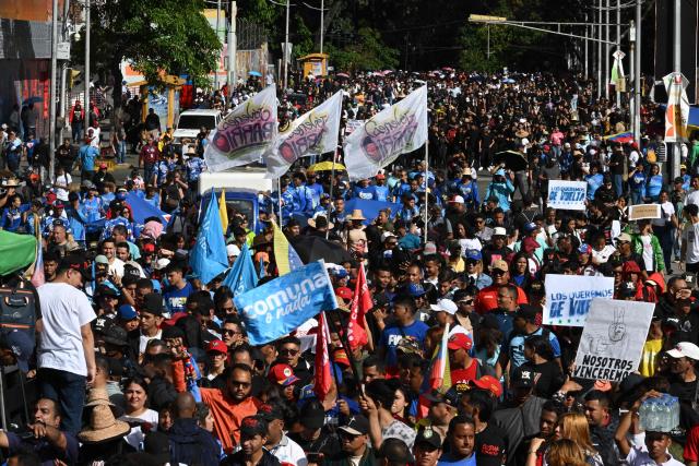 People attend a march in Caracas on January 8, 2026, to demand the release of deposed Venezuelan president Nicolas Maduro and his wife Cilia Flores, snatched and taken to New York on January 3 to face trial on drug and weapons charges. Venezuela on January 8 announced the release of a "large number" of prisoners, some of them foreigners, in an apparent concession to the United States after its ouster of ruler Nicolas Maduro. (Photo by Federico PARRA / AFP)