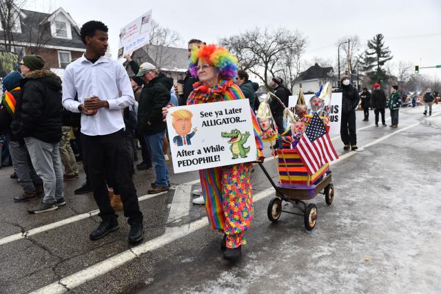 A woman dressed in clown costume holding an anti-Trump sign, rolls her wagon while clergy, faith and community leaders gather to call for ICE to leave the community following the fatal shooting of Renee Good during a law enforcement operation in Minneapolis, Minnesota, on January 8, 2026. A US Immigration and Customs Enforcement (ICE) agent shot and killed an American woman on the streets of Minneapolis January 7, leading to huge protests and outrage from local leaders who rejected White House claims she was a domestic terrorist. The woman, identified in local media as 37-year-old Renee Nicole Good, was hit at point blank range as she apparently tried to drive away from agents who were crowding around her car, which they said was blocking their way. (Photo by Octavio JONES / AFP)
