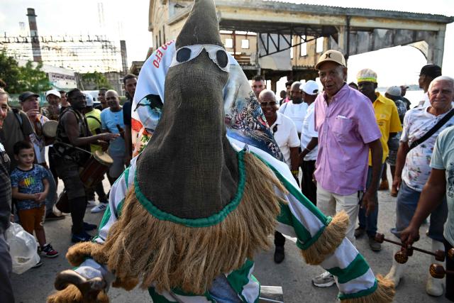 An Ireme, the masked dancer of the male religious secret society known as Abakua (or Nanigo), performs during Abakua Day celebrations in the Regla neighborhood of Havana, Cuba on January 8, 2026. The Afro-Cuban fraternity Abakua, a secret society that only accepts heterosexual men, marks 190 years since its creation in Cuba. The society was founded in the Havana municipality of Regla during Spanish colonial times by African slaves brought to the island from Nigeria. (Photo by YAMIL LAGE / AFP)