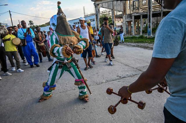 An Ireme, the masked dancer of the male religious secret society known as Abakua (or Nanigo), performs during Abakua Day celebrations in the Regla neighborhood of Havana, Cuba on January 8, 2026. The Afro-Cuban fraternity Abakua, a secret society that only accepts heterosexual men, marks 190 years since its creation in Cuba. The society was founded in the Havana municipality of Regla during Spanish colonial times by African slaves brought to the island from Nigeria. (Photo by YAMIL LAGE / AFP)