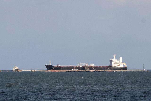 A crude oil tanker is pictured docking in the Maracaibo Lake in Maracaibo, Venezuela, on January 8, 2026. On January 8, three of 11 vessels chartered by Chevron were transporting oil from Venezuela to the US, according to an AFP analysis of ship-tracking data, as export sanctions raised concerns over the South American country's storage capacity. (Photo by Maryorin Mendez / AFP)