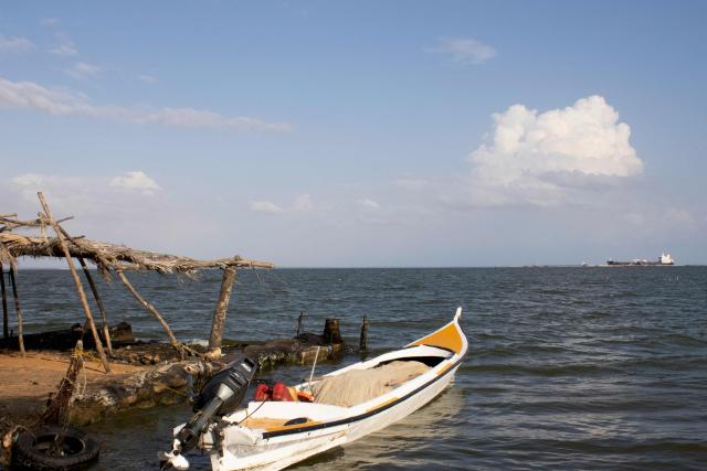 A crude oil tanker is pictured docking in the Maracaibo Lake in Maracaibo, Venezuela, on January 8, 2026. On January 8, three of 11 vessels chartered by Chevron were transporting oil from Venezuela to the US, according to an AFP analysis of ship-tracking data, as export sanctions raised concerns over the South American country's storage capacity. (Photo by Maryorin Mendez / AFP)