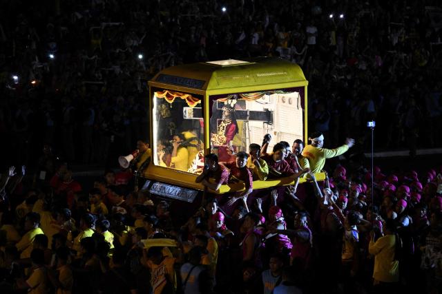 Philippine catholic devotees join along with the carriage carrying the image of Jesus Nazarene during the annual religious procession in Manila on January 9, 2026. (Photo by TED ALJIBE / AFP)