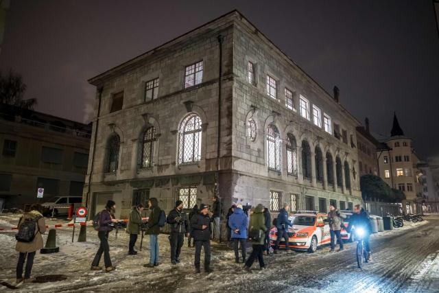 Journalists are waiting next to the Office of the public prosecutor of the Canton of Valais prior to the hearing of French owners of Le Constellation bar in Sion on January 9, 2026. The French couple, facing charges of manslaughter by negligence, bodily harm by negligence and arson by negligence, have been called in for questioning after 40 people, most of them teenagers, were killed, while 116 were injured in a fire that ripped through a bar in the luxury Alpine ski resort of Crans-Montana on New Year's Eve. (Photo by Fabrice COFFRINI / AFP)