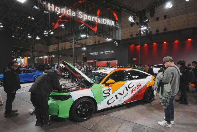 The Civic e:HEV RS Prototype is displayed at the Honda booth during the Tokyo Auto Salon 2026 at Makuhari Messe in Chiba City on January 9, 2026. (Photo by Kazuhiro NOGI / AFP)