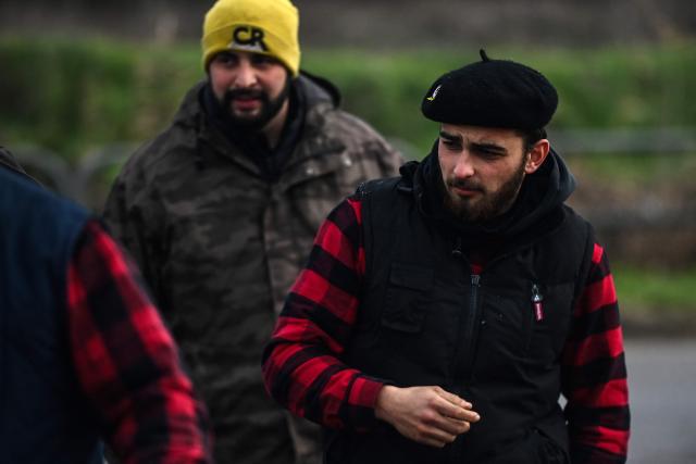 Farmers of the Coordination Rurale (CR) 33-Gironde farmers union react as they block an access to the Dock des Petroles d'Ambes oil depot with their tractors as part of a demonstration to push the French government to block the Mercosur trade deal and to protest against its handling of the nodular dermatitis (CND) epidemic, in Bassens outside Bordeaux, south-western France on January 9, 2026. (Photo by Christophe ARCHAMBAULT / AFP)