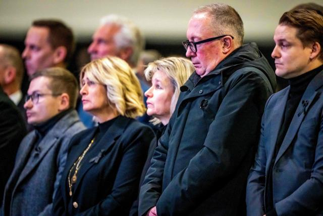President of the municipality of Crans-Montana, Nicolas Feraud (2nd R) flanked by families and relatives of the victims, emergency responders and firefighters stands at attention as he observes a minute of silence during a tribute ceremony for the victims of the deadly fire that ripped through the bar Le Constellation on New Year's Eve, in Crans-Montana on January 9, 2026. All of Switzerland will mark a national day of mourning on January 9 for the dozens of mostly teenagers killed when fire ravaged a ski resort bar crammed with New Year revellers. Just over a week after the tragedy at the Le Constellation bar in Crans-Montana, which left 40 dead and 116 injured, the wealthy Alpine nation will come to a standstill for a minute of silence at 2:00 pm (1300 GMT). (Photo by MAXIME SCHMID / AFP)