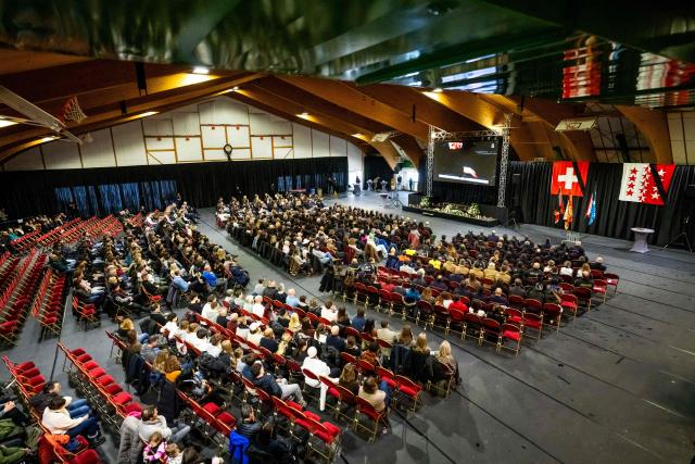 Famailies and relatives of the victims along with emergency responders and firefighters attend a tribute ceremony for the victims of the deadly fire that ripped through the bar Le Constellation on New Year's Eve, in Crans-Montana on January 9, 2026. All of Switzerland will mark a national day of mourning on January 9 for the dozens of mostly teenagers killed when fire ravaged a ski resort bar crammed with New Year revellers. Just over a week after the tragedy at the Le Constellation bar in Crans-Montana, which left 40 dead and 116 injured, the wealthy Alpine nation will come to a standstill for a minute of silence at 2:00 pm (1300 GMT). (Photo by MAXIME SCHMID / AFP)