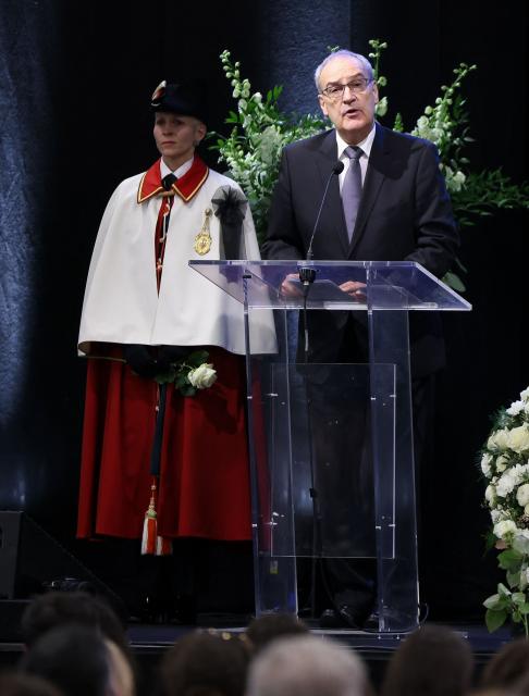 Switzerland's President Guy Parmelin delivers remarks during a tribute ceremony for the victims of the deadly fire that ripped through the bar Le Constellation in Crans-Montana on New Year's Eve, in Martigny, on January 9, 2026. All of Switzerland will mark a national day of mourning on January 9 for the dozens of mostly teenagers killed when fire ravaged a ski resort bar crammed with New Year revellers. Just over a week after the tragedy at the Le Constellation bar in Crans-Montana, which left 40 dead and 116 injured, the wealthy Alpine nation will come to a standstill for a minute of silence at 2:00 pm (1300 GMT). (Photo by Pierre Albouy / POOL / AFP)
