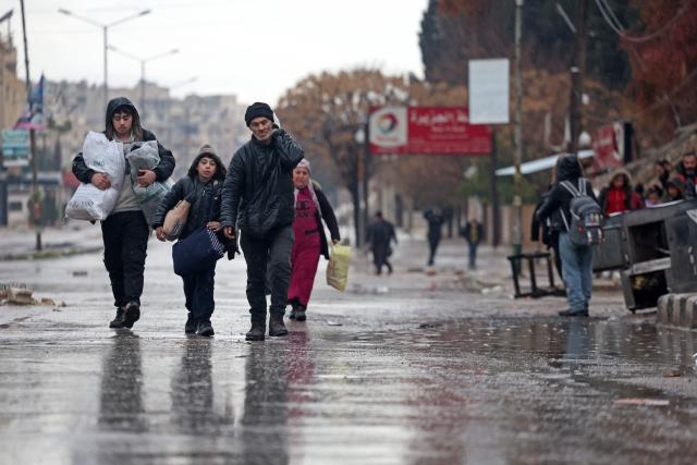 Residents of Aleppo's Sheikh Maqsoud area evacuate their neighbourhood after warnings from the Syrian army that called on civilians to get out of harms way, following the refusal of Kurdish fighter forces to leave Aleppo, on January 9, 2026. Syria's army warned on January 9 it would renew attacks against a Kurdish-majority district of Aleppo and urged residents to evacuate, state media reported, hours after a ceasefire was announced. (Photo by OMAR HAJ KADOUR / AFP)