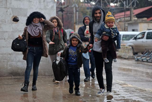 Residents of Aleppo's Sheikh Maqsoud area evacuate their neighbourhood after warnings from the Syrian army that called on civilians to get out of harms way, following the refusal of Kurdish fighter forces to leave Aleppo, on January 9, 2026. Syria's army warned on January 9 it would renew attacks against a Kurdish-majority district of Aleppo and urged residents to evacuate, state media reported, hours after a ceasefire was announced. (Photo by OMAR HAJ KADOUR / AFP)