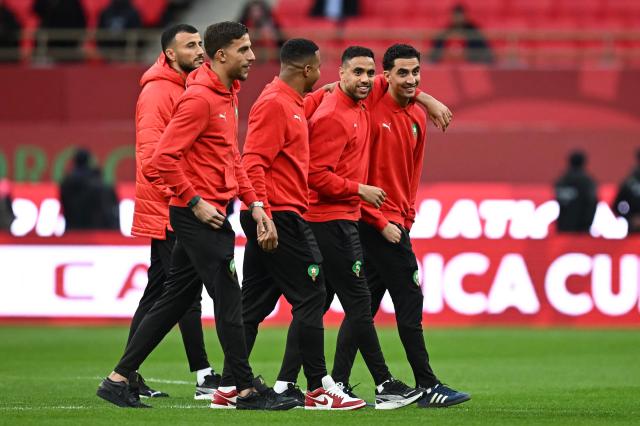 Morocco's defender #06 Romain Ghanem Saiss (L), Morocco's goalkeeper #22 El Mehdi Al Harrar (2L), Morocco's defender #15 Mohamed Chibi (2R) and Morocco's midfielder #14 Oussama Targhalline (R) arrive for the Africa Cup of Nations (CAN) quarter-final football match between Cameroon and Morocco at the Prince Moulay Abdallah stadium in Rabat on January 9, 2026. (Photo by Paul ELLIS / AFP)