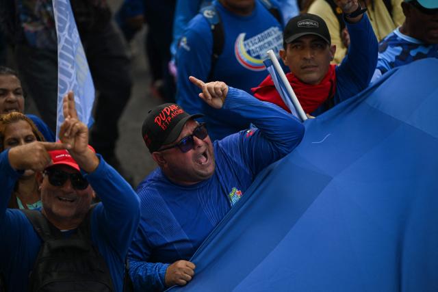 Members of Venezuela’s fishing and aquaculture sector attend a march in Caracas on January 9, 2026, to demand the release of deposed Venezuelan president Nicolas Maduro and his wife Cilia Flores, snatched and taken to New York on January 3 to face trial on drug and weapons charges. Colombia's President Gustavo Petro on January 9. urged Venezuela to jointly fight drug-traffickers operating across the two countries' border, after the United States threatened further armed action in the region. (Photo by Federico PARRA / AFP)