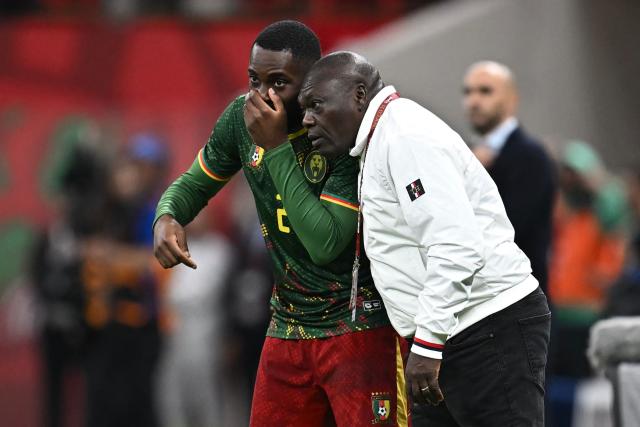 Cameroon's head coach David Pagou speaks with Cameroon's defender #02 Junior Tchamadeu during the Africa Cup of Nations (CAN) quarter-final football match between Cameroon and Morocco at the Prince Moulay Abdallah stadium in Rabat on January 9, 2026. (Photo by Paul ELLIS / AFP)