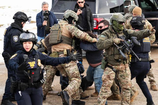 Federal agents detain a protester near the Bishop Henry Whipple Federal Building in Minneapolis, Minnesota, on January 9, 2026. A US Immigration and Customs Enforcement (ICE) agent shot and killed an American woman on the streets of Minneapolis January 7, leading to huge protests and outrage from local leaders who rejected White House claims she was a domestic terrorist. The woman, identified in local media as 37-year-old Renee Nicole Good, was hit at point blank range as she apparently tried to drive away from agents who were crowding around her car, which they said was blocking their way. (Photo by Charly TRIBALLEAU / AFP)