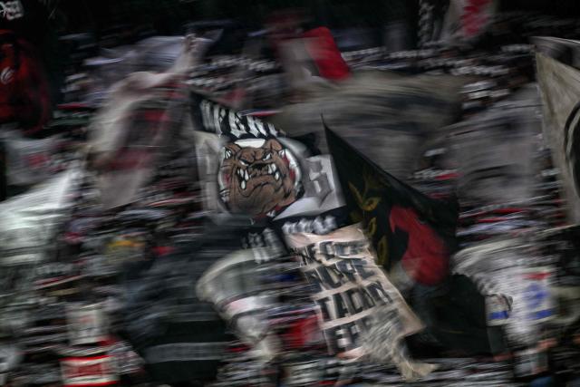 Eintracht fans wave flags as they sing prior to the German first division Bundesliga football match between Eintracht Frankfurt and BVB Borussia Dortmund in Frankfurt am Main, western Germany, on January 9, 2026. (Photo by Kirill KUDRYAVTSEV / AFP) / DFL REGULATIONS PROHIBIT ANY USE OF PHOTOGRAPHS AS IMAGE SEQUENCES AND/OR QUASI-VIDEO