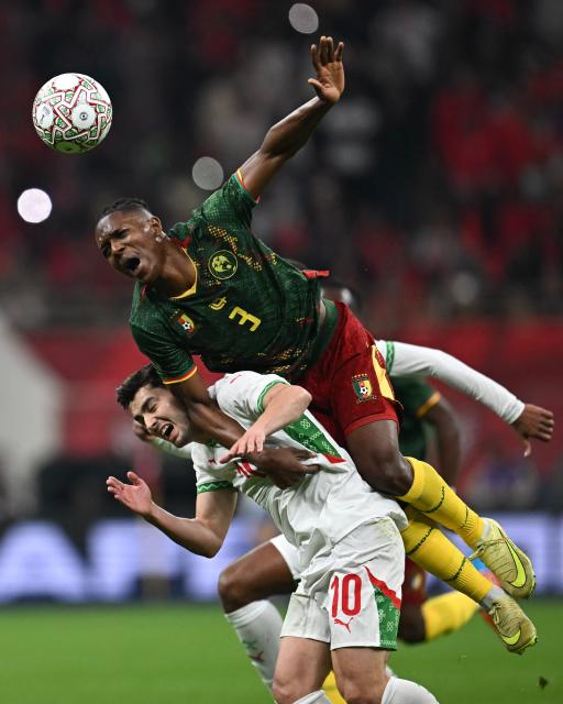 Morocco's forward #10 Brahim Diaz and Cameroon's defender #03 Che Malone fights for the ball during the Africa Cup of Nations (CAN) quarter-final football match between Cameroon and Morocco at the Prince Moulay Abdallah stadium in Rabat on January 9, 2026. (Photo by Paul ELLIS / AFP)